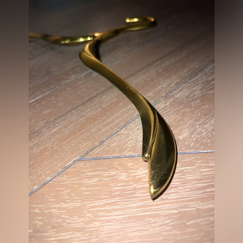 Art deco, golden brass hanger to display wedding gown for photos.
